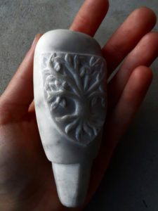 Pommeau de canne en marbre avec une armoirie imaginaire représentant un arbre.